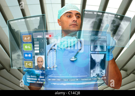 Doctor with high-tech computer screen viewing patient data Stock Photo