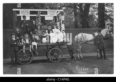 Original and clear Edwardian era postcard of Temperance Society campaigners (some characters) on a horse drawn cart or wagon with signs and dressed to show the perils of drink, possibly a carnival float, possibly from  Devon as the Cleave Photo could indicate (or could be the photographer's name), likely South West England, UK - circa 1910 Stock Photo