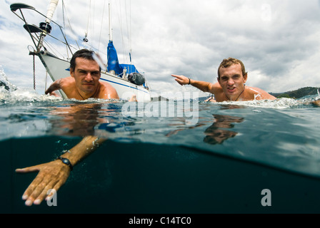 Two guys heading out for surf in Costa Rica Stock Photo