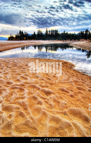 Sunrise with frost covered sand at Taylor Creek on the west shore of Lake Tahoe, CA. Stock Photo