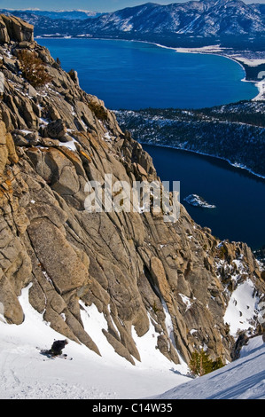 A skier descends Emerald Chute high above Emerald Bay and Lake Tahoe in the winter, CA. Stock Photo