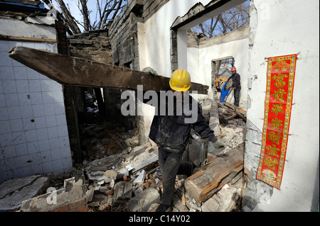Chinese workers demolish an old buildings abutitng on Zhongnanhai - headquarters of Chinese government in Beijing. 06-Mar-2011 Stock Photo