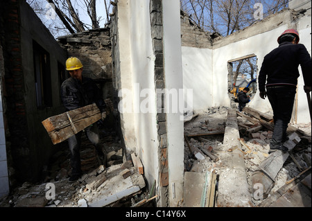 Chinese workers demolish an old buildings abutting on Zhongnanhai - headquarters of Chinese government in Beijing.06-Mar-2011 Stock Photo