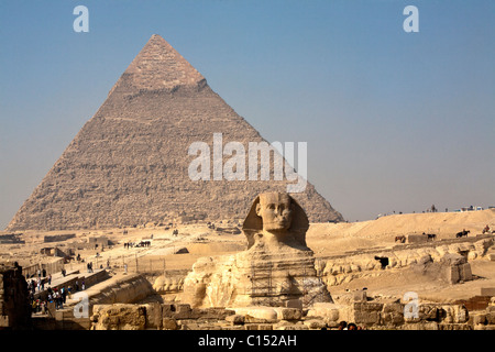 The morning smoke clears to view both the Great Sphinx of Giza and the Pyramid of Khafre (Chephren) in Egypt Stock Photo