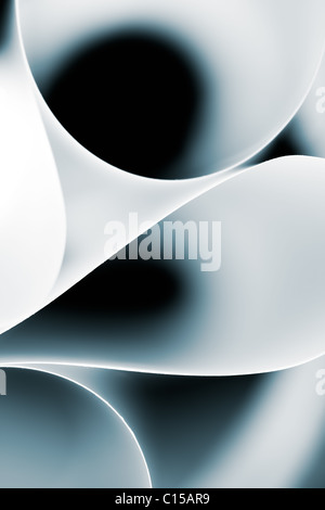 a macro, abstract, background picture of a white twisted sheet of paper, in a circle, curved shape, on black background Stock Photo