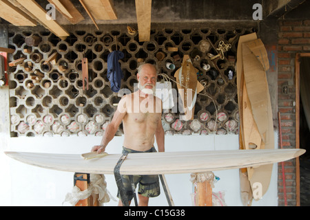 Old Man Making Balsa Surfboard In Ecuador Stock Photo
