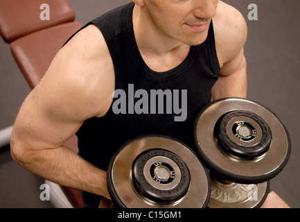 Man lifting weights GYM Muscle fitness Stock Photo