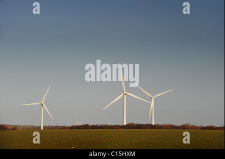 Wind Turbines Generating Renewable Electrical Power on a bright day with blue sky Stock Photo