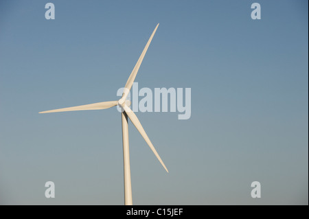 Wind Turbines Generating Renewable Electrical Power on a bright day with blue sky Stock Photo