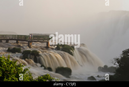 Old couple walking on a bridge at Iguassu waterfalls, Brazil Stock Photo