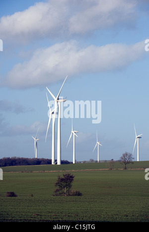 Wind Turbines Generating Renewable Electrical Power on a bright day with blue sky Stock Photo