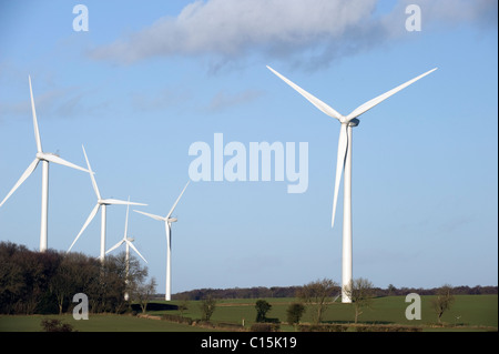 Wind Turbines Generating Renewable Electrical Power on a bright day with blue sky Stock Photo
