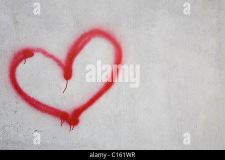 Red heart shape on white wall Stock Photo