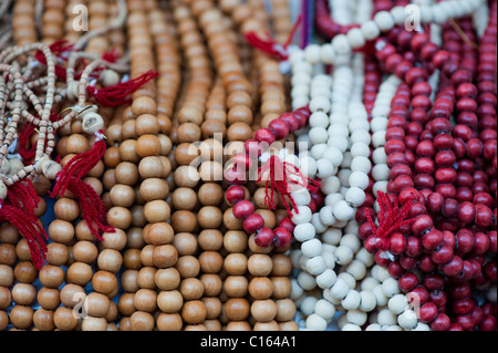 Mans hand using Indian Rudraksha / Japa Mala prayer beads and