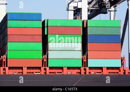 Stacked containers on ship deck in harbor Stock Photo