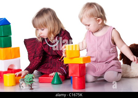 Children playing with blocks isolated on white Stock Photo