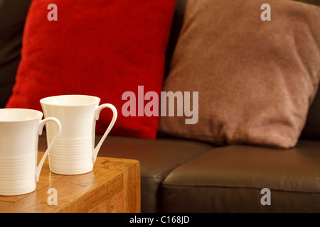 Detail of a stylish coffee house with sofa and mugs. Plenty of space for text Stock Photo