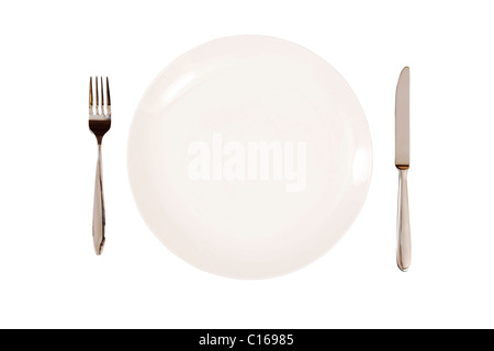 White plate with knife and fork isolated on a white background. With clipping path Stock Photo