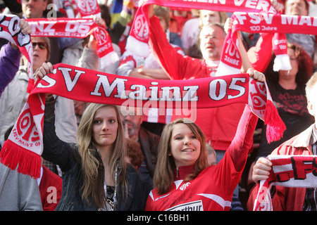 Fans of FSV Mainz 05 showing their team scarves Stock Photo