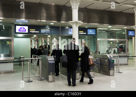 People check in at St Pancras International Eurostar railway station ...