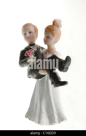 Porcelain bride and groom, bride carrying the groom Stock Photo