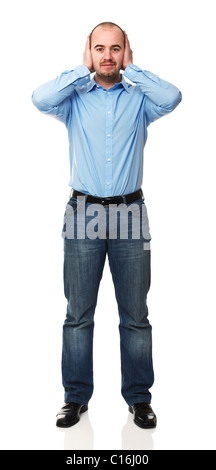 standing young man with hands on his ears Stock Photo