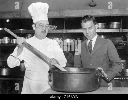 Historic photograph, cook stirring a pot with a large spoon Stock Photo