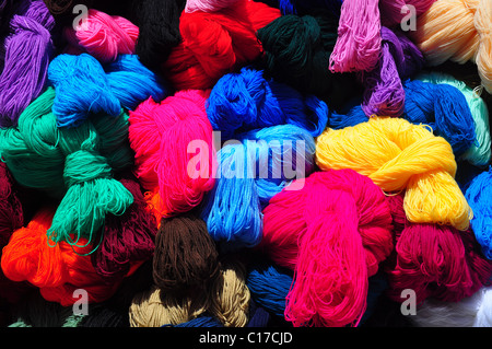 Collection of brightly coloured balls of wool on traditional market stall Stock Photo
