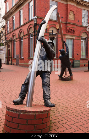 The Arc (Y Bwa) metal figures sculpture by David Annand in town centre. Lord Street, Wrexham, North Wales, UK. Stock Photo