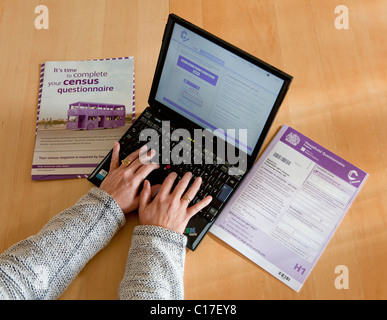 person completing the 2011 census questionnaire online at home on a laptop computer uk gb Stock Photo