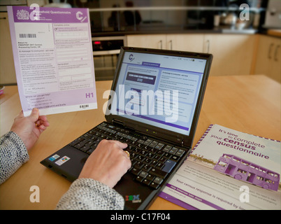 person completing the 2011 census questionnaire online at home on a laptop computer uk gb Stock Photo