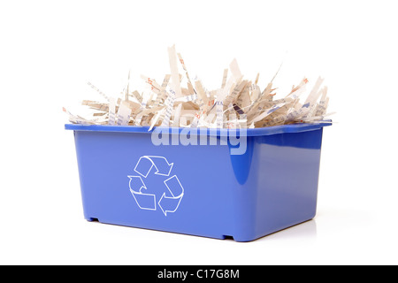 Paper cuttings in blue plastic disposal bin with white recycle symbol - over white background Stock Photo