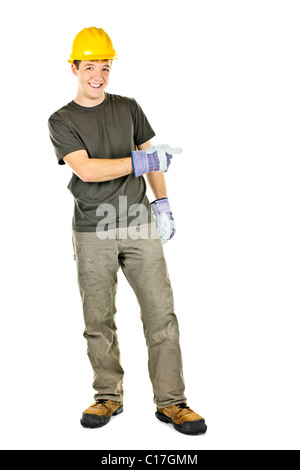 Construction worker with hard hat pointing to the side isolated on white background Stock Photo