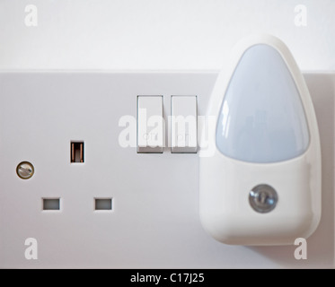Close-up of a night-light plugged in to a double electric socket. Stock Photo