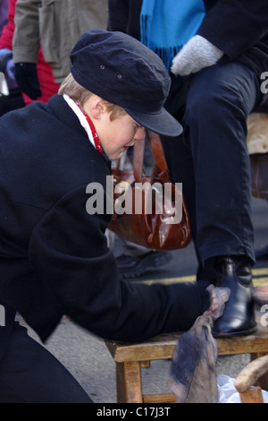 Boy dressed as shoe-shine boy at Grassington Dickensian festival, Yorkshire, England, UK Stock Photo