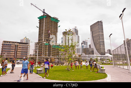 PANAMA CITY, PANAMA - People in park and skyscrapers on Balboa Avenue. Stock Photo