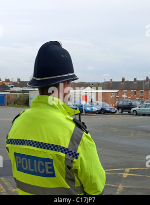 A British Police Officer on the Beat in a Town Centre Stock Photo