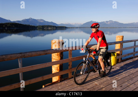 Bicyclist at Dampfersteg in Chieming, Chiemsee, lake, Chiemgau, Bavaria, Germany, Europe Stock Photo