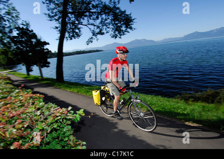 Bicyclist at Dampfersteg in Chieming, Chiemsee, lake, Chiemgau, Bavaria, Germany, Europe Stock Photo
