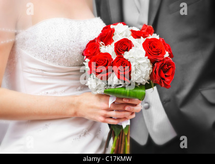 Bride and groom holding bridal bouquet close up Stock Photo