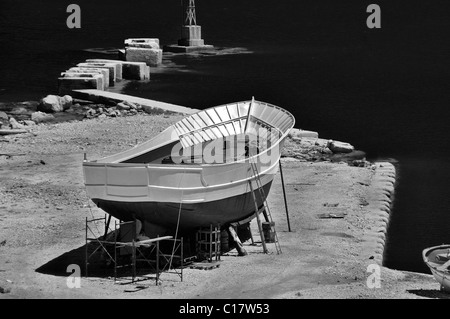 Wooden boat at shipyard in the harbor of Zakynthos, Greece. Black and white. Stock Photo