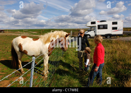 Woman and two children with an Icelandic horse, camper van in te back, in Laugarvatn, Iceland, Europe Stock Photo