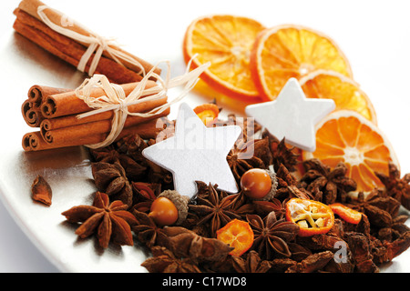 Christmas platter with decorative stars, cinnamon sticks, star anise and dried orange slices Stock Photo