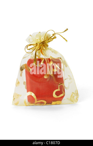 Red jewellery box in gold sachet on white background
