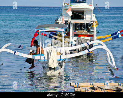 Traditional Asian outrigger fishing boat, called a Jukun in Indonesia and a Banca in the philippines Stock Photo