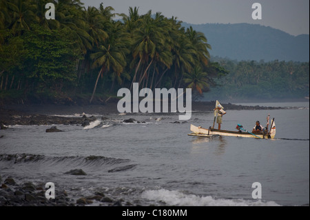 Balinese fishermen pull up on the beach in Tembok, Bali, after a night of fishing for mackerel in a traditional outrigger. Stock Photo