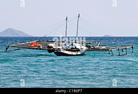 Traditional Jukun or banca outrigger fishing boat Stock Photo