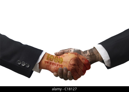 Businessmen shaking hands made of paper currency Stock Photo