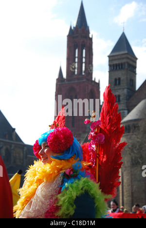 Carnival crowd at Vrijthof square with Red Tower of Protestant St Johns Church and Catholic St Servatius church Maastricht Stock Photo