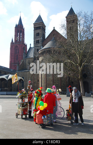 Carnival crowd at Vrijthof square with Red Tower of Protestant St Johns Church and Catholic St Servatius church Maastricht Stock Photo